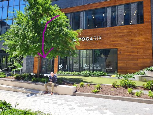 Front door faces a promenade between two large buildings. at Simons Says Dip This in Raleigh