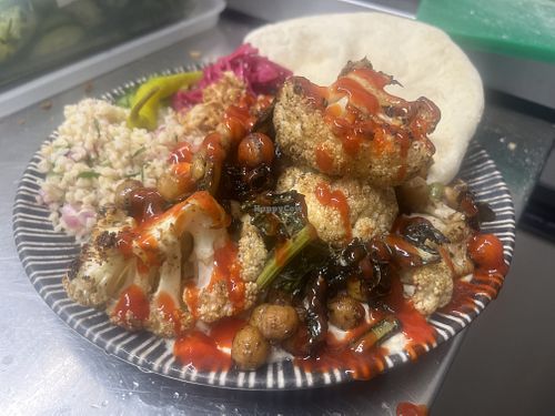 Sriracha and lime cauliflower, chickpea and kale bake with tabouleh and flatbreads  at The Deli Social in Sutton Coldfield