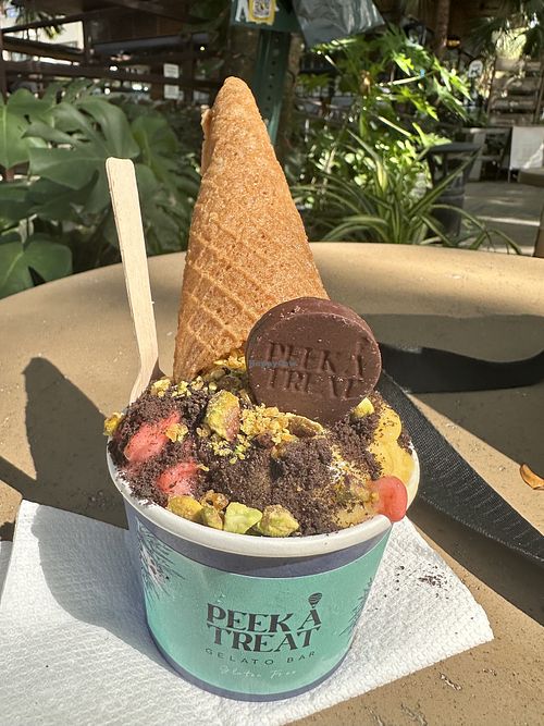 Vegan mango and strawberry gelato with pistachio topping and vegan waffle cone    at Peek A Treat in Miami