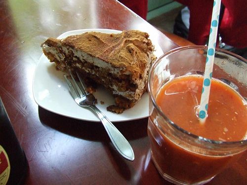 Tiramichai cake and a glass of carrot/pear/ginger juice  at Koffie ende Koeck in Amsterdam