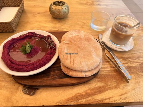Beetroot Hummus with pita and oat milk flat white  at George's in Mallorca