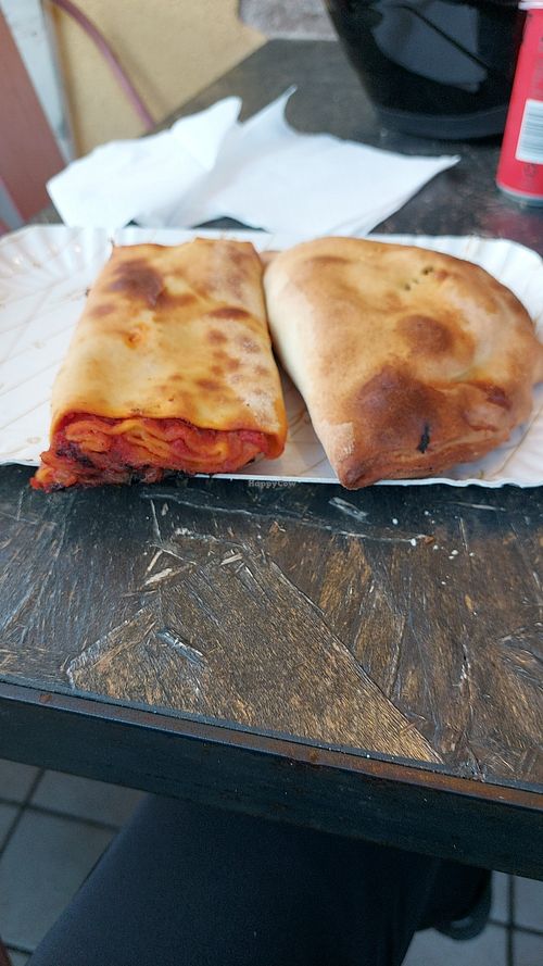 Scaccia with tomato sauce and onions and calzone with spinach,black olive and dry tomato at Squitty Di Cintoli Battista Maria in Ragusa