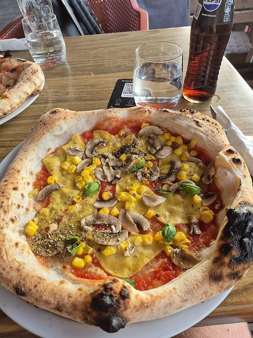 Pizza with vegan cheese. The crust was thin but really tasty! at KOPAKABANA in Braslovce