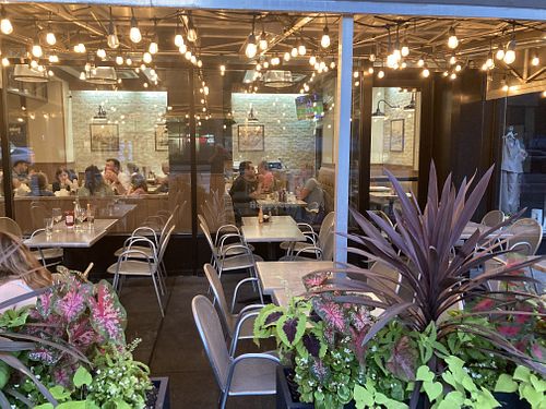 Outdoor and indoor seating  at Gracie Mews Diner in New York City