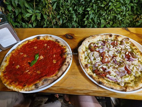 Pizza marinara e pizza con pesto, cipolla e pomodorini secchi (e mozzarella di riso) at La Caorlotta in Caorle