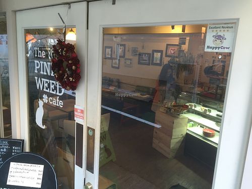 Happy Cow sticker at The PINK WEED Cafe in Kobe