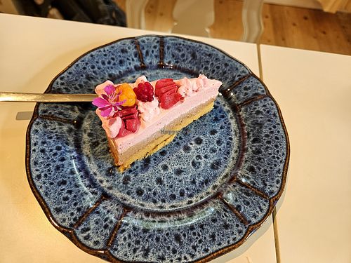 Mousse cake with a cloudberry and arctic raspberry on top at Teehuone Taigahetki in Kemijaervi