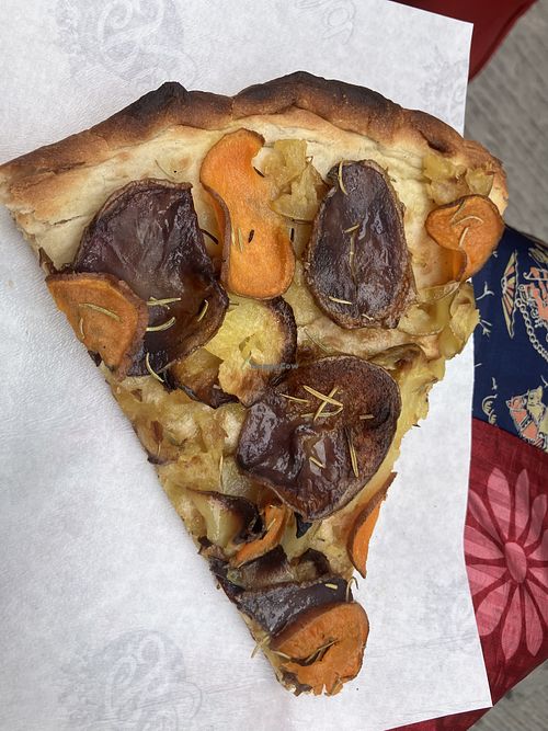 Vegan pizza slice with potatoes, onion and rosemaryy  at Pizzeria Reginella  in Perugia