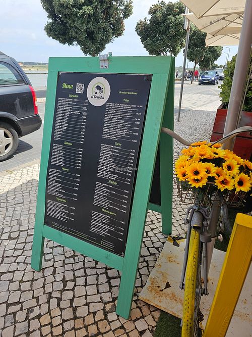 The menu (you can see the lagoon across the narrow road) at Restaurante A Cozinha in Praia De Mira