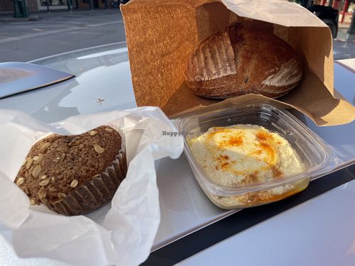 Sourdough muffin, rustic sourdough bread loaf, roasted garlic hummus  at Fleur Bake Shop in Whitefish