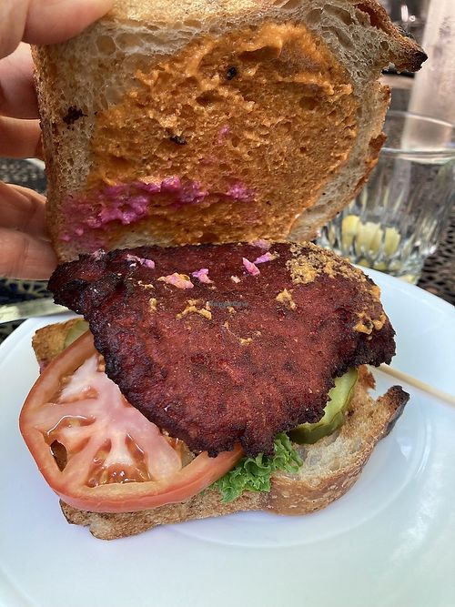old major house burger made with cannellini beans and beets and a vegan sauce. Made vegan by swapping out the milk-based bun with vegan sourdough bread and holding cheese sauce at Heart of Gold in Cleveland