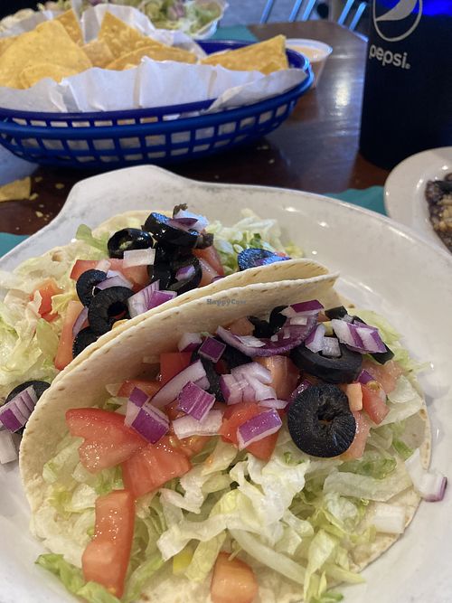 Taco toppings tacos 🤣 Their vegan option is limited to lettuce, red onion, tomatoes, and olives - nothing more. No veggies, no innovation. Beware, Guac has dairy.  at El Toro Mexican Restaurant  in Alachua