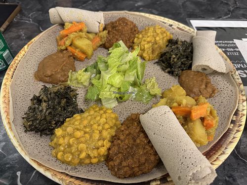 Veggie Combo - shiro (thick seasoned legume sauce/gravy), alcha kik (turmeric yellow lentils/chickpeas), gomen (greens), misir (red lentil stew) + injera    at Lalibela Ethiopian Cuisine in Redding