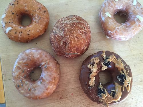 Lemon lavender, Thai tea, churro cream-filled, rose cardamom, and chocolate peanut butter Oreo. at Donut Panic in San Diego