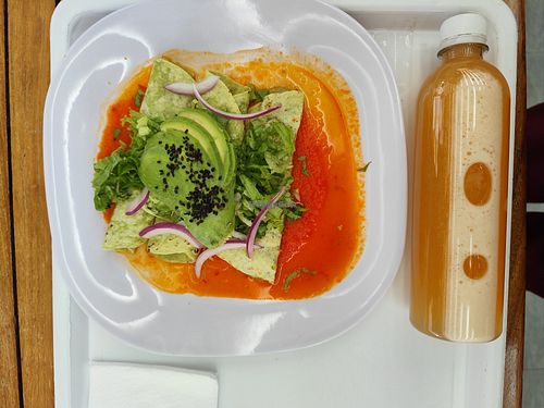Enchiladas and agua fresca melon at La Buena Tierra Antara in Ciudad De México