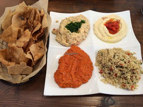 Vegan platter of 'extras' : Mediterranean guacamole, hummus, quinoa salad, mharama, and pita chips. at The Chickpea in West Palm Beach