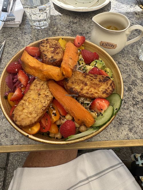 The Buddha Bowl comes with fresh avocado, garbanzo beans, pickled red cabbage, cherry tomatoes, sweet potatoes, lettuce, rice, tempeh. Dressing is cumin, turmeric curry coriander.  at Josephine Restaurant in Chamonix-mont-blanc