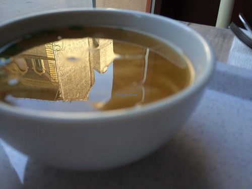 Miso soup with the reflection of a beautiful building in it.  at Rizsa17 in Budapest