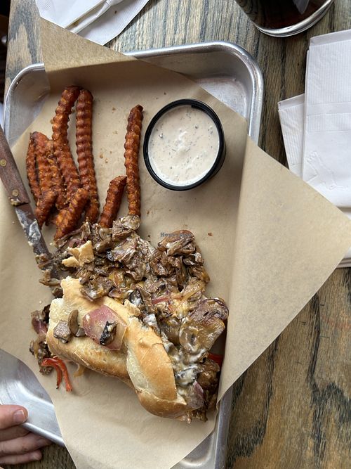 Philly cheese steak with sweet potato fries. My husband had already ate some of it before the picture was taken. He loved it!   at Midway Bar in Midvale
