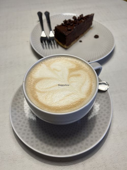 Latte and chocolate cake  at Vegan Restoran V in Tallinn