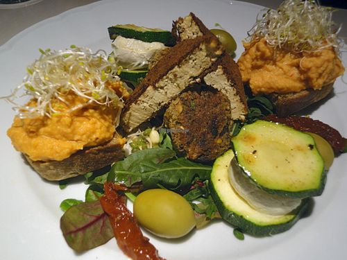 Snack platter: bellpepper-hummus, smoked tofu, zucchini with cashew-cream, chickpea-mushroom balls, olives, sundried tomatoes.  at Vegan Restoran V in Tallinn