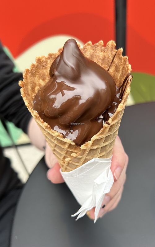 Vegan soft serve vanilla cone dipped in vegan chocolate in vegan waffle cone. Yummy!  at Chocolats Favoris in Vancouver