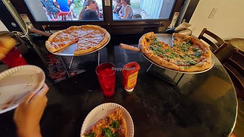 One plain vegan pizza and one with spinach at Pleasant Street Pizza Pub in Gainesville