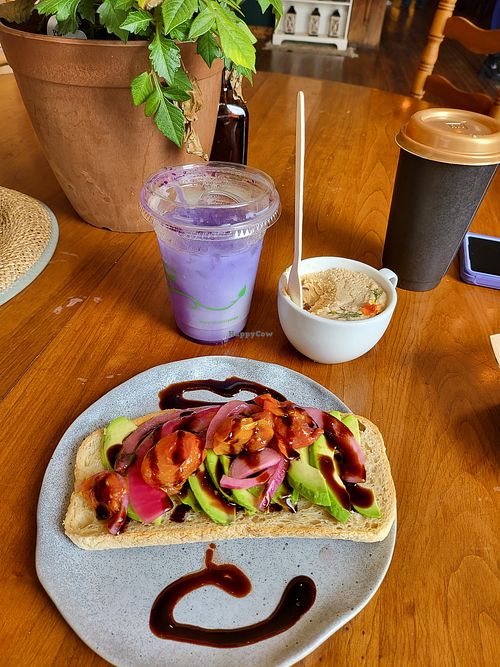 Vegan Avocado toast with fresh avocado, picked red onions, and roasted grape tomatoes. at Elevenses in Brunswick