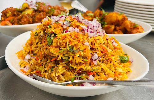 Fragrant Vegetable Biryani with basmati rice, garden-fresh vegetables, and traditional Indian spices. A colorful, flavorful vegan dish perfect for a satisfying and aromatic meal.  at India Express in Denver