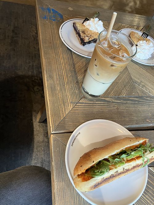 Began breakfast with iced oat latte, blueberry cake and sandwich  at Espresso House in Mora