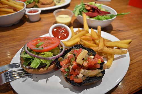 Portobello mushroom burger with salad, tomatoes and baked garlic, all vegan & delicious @ Veggie Grill, Mountain View at Veggie Grill in Mountain View