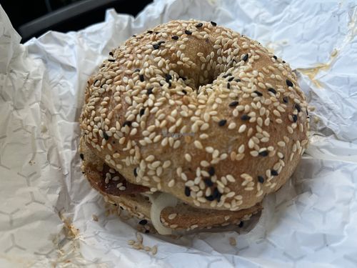 sesame bagel with vegan bacon, butter and onions  at Julio's Bagels in Richmond