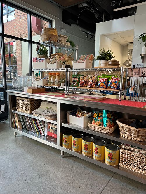 Inside the space, with some cute snacks showcasing lots of cookbooks at Little Kim in Ann Arbor
