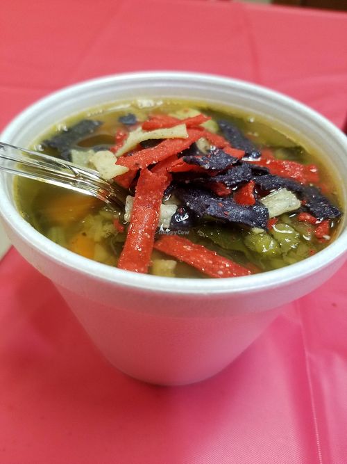 Tasty Vegan Lentil Veggie Soup with colorful mini tortilla strips at Spread N Buns at Spread N Buns Craft Soups & Sandwiches in Decatur