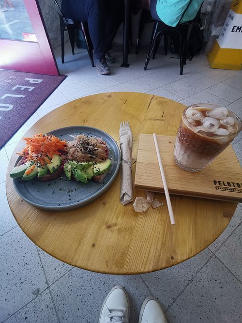 Iced latte and super toast with cream of beetroot, avocado and sauerkraut at Peloton Café & Cycling in Viana Do Castelo