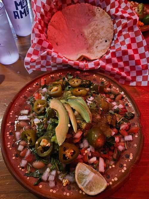 Handmade tortillas under pintos Salsa Fresca and avocado. I love it. at Mas Amor in Chico
