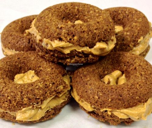 Iss' Magic Mixes Oatmeal Cafe Baked Wheat-Free Pumpkin Spice Doughnuts filled with vegan pumpkin frosting at Iss' Magic Mixes Oatmeal Cafe in Mesa