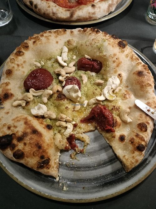 Vegan pizza with courgette pesto, tomato, cashews and tofu ricotta cream at PIZZERIA CHICCO in Toscana