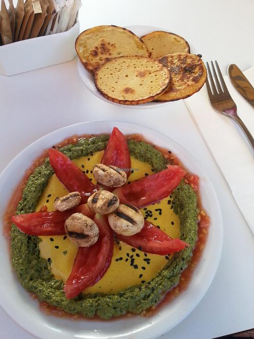 Starter with Humusomlette and grilled mushrooms, Tomato, Pesto and a delicious variaty of Tahini at Anastasia in Tel Aviv