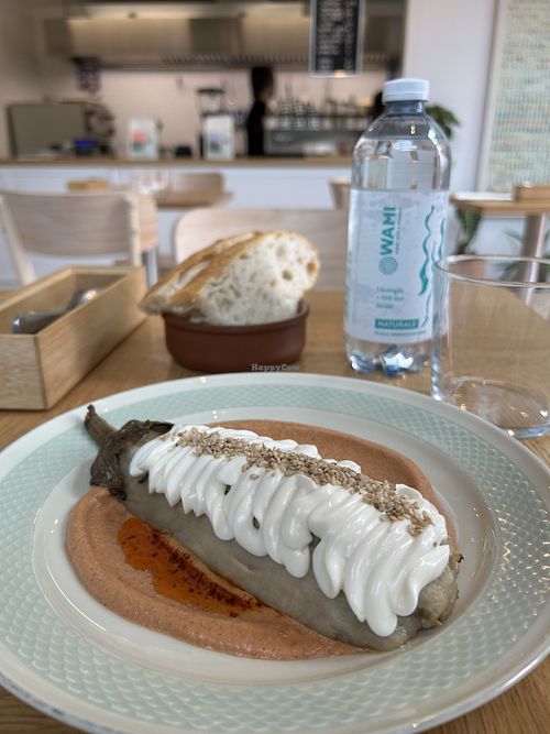 roasted eggplant, gojju cream (tomato and spices), mint and coriander chutney, vegan sauce, sesame seeds  at June Collective in Lombardia