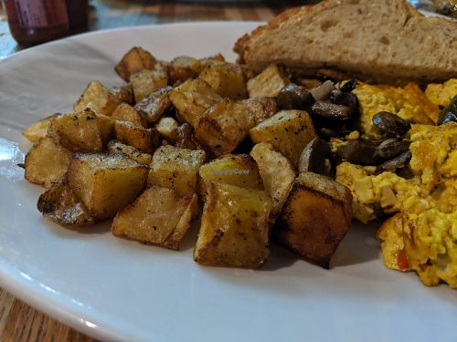 Generous portion of tofu scramble with crisp potato and gluten free toast. at Black River Cafe in Oberlin