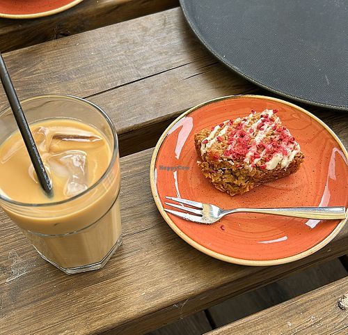 Oat milk iced latte and raspberry and coconut flapjack.   at Chestnuts Coffee in Norwich