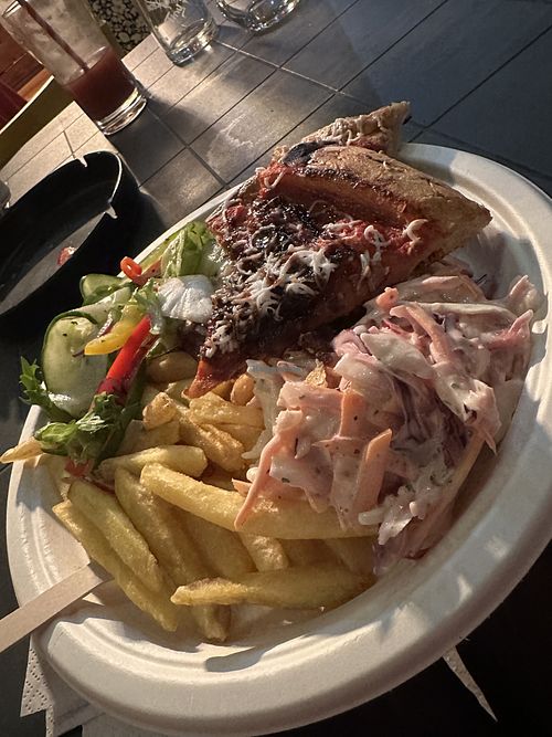 Pizza, salad, chips and coleslaw   at Slice Guys at Yellow Arch Studios in England