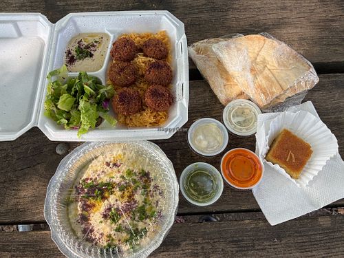 Wonderful dish including hummus, rice, pita, Baba Ghanoush, salad, great spicy dips. at Jerusalem Restaurant in Peoria