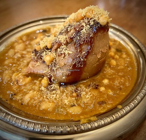 Vegan Samosa Chaat - crispy samosa served over spicy chickpeas with assorted sweet, tangy, and spicy chutneys and crunchy toppings. Ask without the yoghurt to make it vegan.  at Dhol & Soul Indian Bistro in Noord-brabant