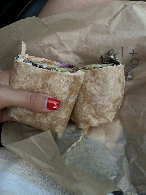 Veggie hummus wrap with pickled carrots added   at Purple Tomato Farmers Market in Lincoln