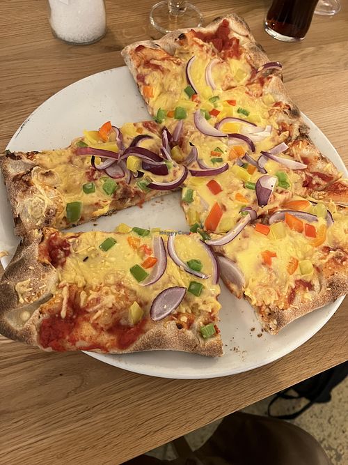 Vegan pizza with vegan cheese, onions and peppers  at Lalandia buffet in Billund
