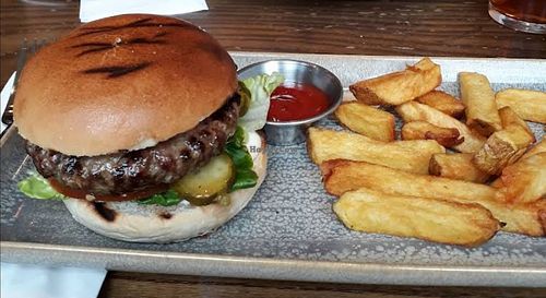 Hackney plant-based quinoa & beetroot jerk seasoned burger topped with smoky Applewood Vegan cheese, plant-based mayo, tahini-dressed kale, balsamic beef tomato triple cooked chips at The Hand & Flower, Olympia in England