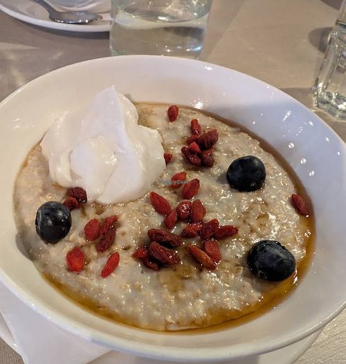 Organic porridge with oat milk, Goji berries, banana, coconut yoghurt, maple syrup at The Hand & Flower, Olympia in England