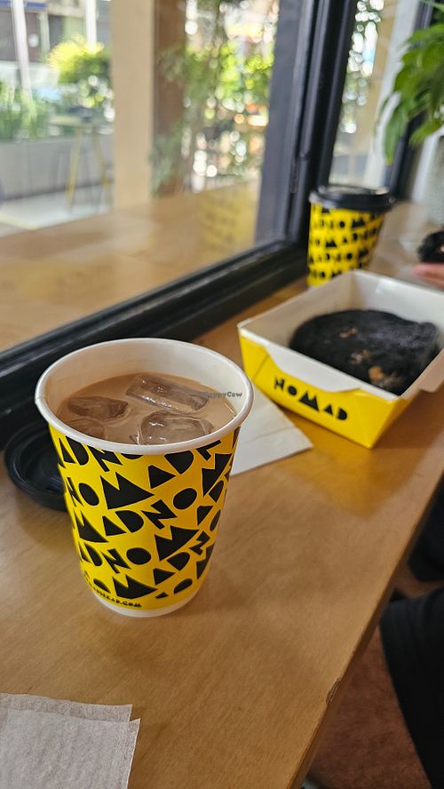 Iced Coffee with oat milk and Mushroom Aubergine Sandwich on the right.
Served in black charcoal bread, roasted portobello, vegan mayo and eggplant spread. at Nomad Bread & Coffee in Lefkosia